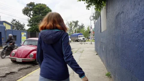 Oaxaca Mexico October 9 2024: A woman walking on street back of a person tourist Stock Footage 287409360
