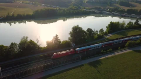 ÖBB CityShuttle passenger train along the river Inn in evening light Video stock 341468174