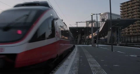 OBB train enters Vienna Central station, late evening. Hauptbahnhof, transport. Video stock 229779736