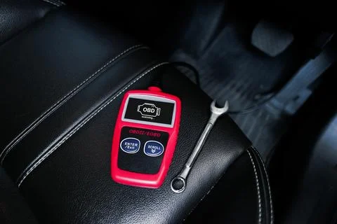 OBD2 or OBD scanner and wrench on car leather seat to fixing car engine system Stock-Fotos