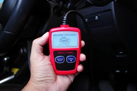 OBD2 or OBD scanner in a auto mechanic hand for engine system analysis Stock Photos