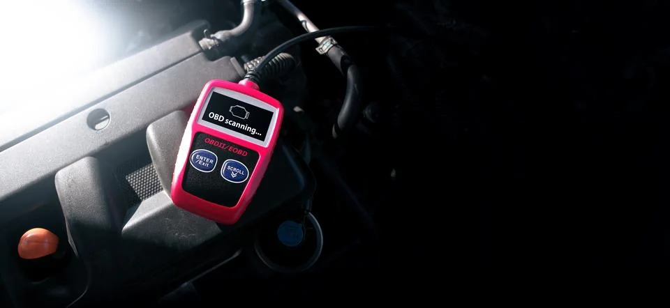 OBD2 or OBD scanner tool on car engine compartment 库存照片