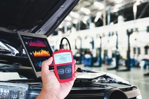 OBD2 or OBD scanner tool and laptop for engine system analysis to fixing car Foto stock