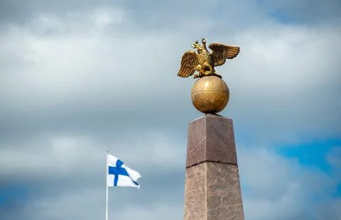 Obelisk with Double-headed eagle and the flag of Finland in Helsinki Stock Photos