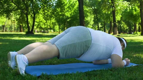 Obese man doing plank in park, weight Stock Video Pond5