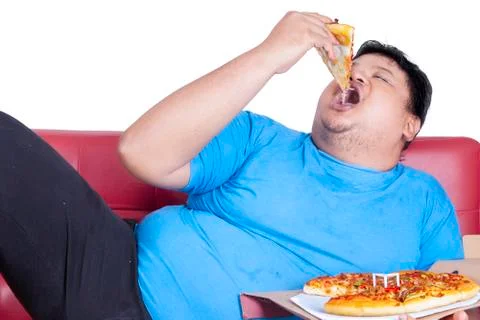Obese person eats pizza Stock Photos