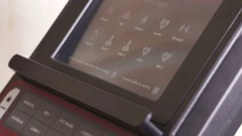 Obese person using fat burn workout program during exercise on elliptical Video stock 75813167