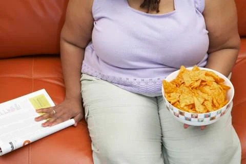 Obese Woman With A Bowl Of Nachos Stock Photos