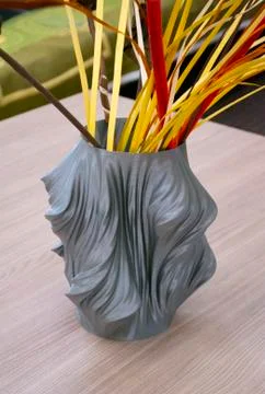 The object created in the 3d printer in the form of a vase is on the table Stock Photos