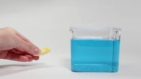 Object Floating and Sinking in Blue Liquid Video stock 308777938