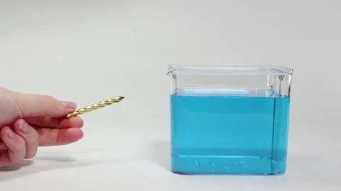 Object Floating and Sinking in Blue Liquid Video stock 309272768