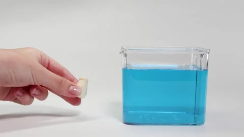 Object Floating and Sinking in Blue Liquid Video stock 309897346