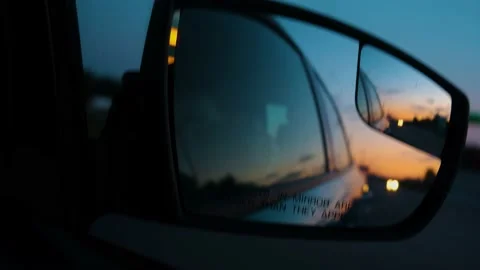 Object in the mirror are closer than it appear. Reflection of the sunset in the Stock Footage 211108490