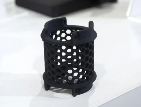 Object printed on 3D printer from molten plastic powder close-up. Model printed Stock Photos