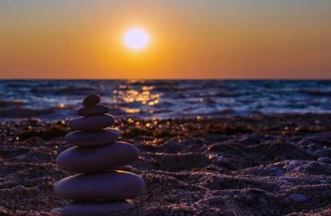 The object of the stones on the beach at sunset. Stock Photos