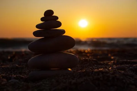 The object of the stones on the beach at sunset. Stock Photos