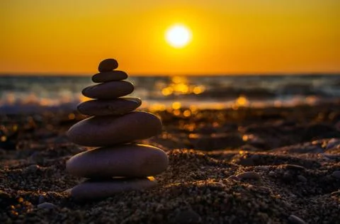 The object of the stones on the beach at sunset. Stock Photos