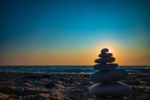 The object of the stones on the beach at sunset. Stock Photos