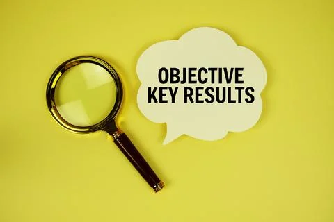 Objective Key Results text with speech bubble and magnifying glass on yello.. Stockfoto's
