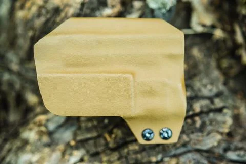 Objective shooting holster on the bark of a tree in the forest Stock Photos