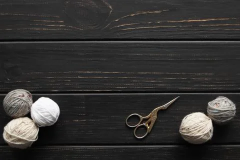 Objects and threads for knitting, dark wooden background, basis for text Stock Photos