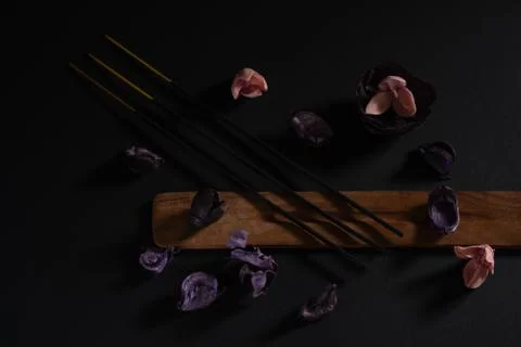 Objects for aromatherapy on a dark background, close-up. Incense and dry pink Stock Photos