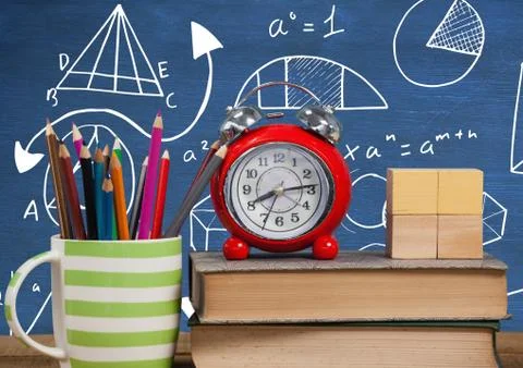 Objects on Desk foreground with blackboard graphics of math equations Foto stock