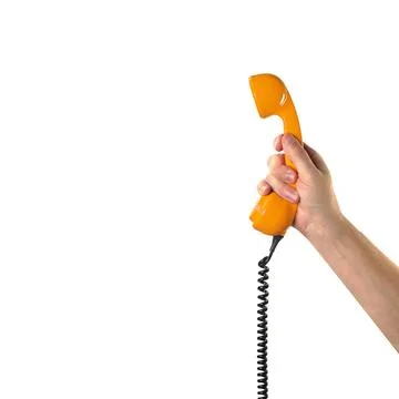 Objects Hands action - Hand holds retro orange phone red handset. Isolated Stock Photos