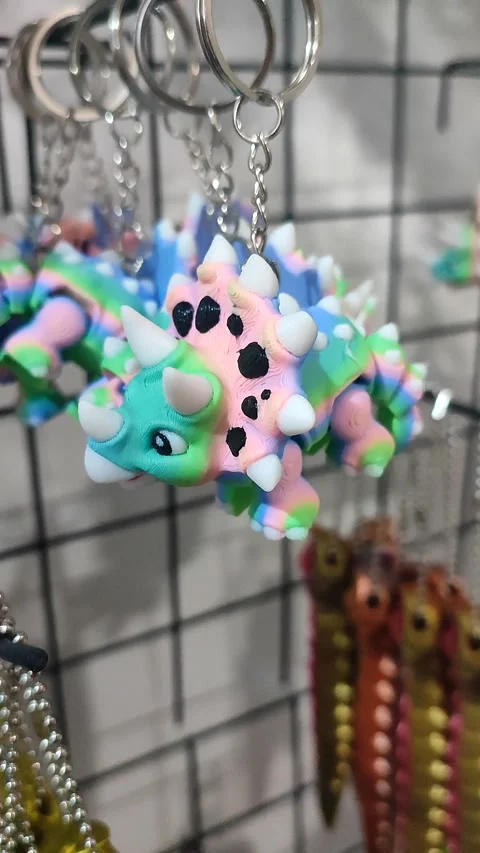 Objects keychains of different models of toys printed on 3D printer Vertical Stock Footage 303955700