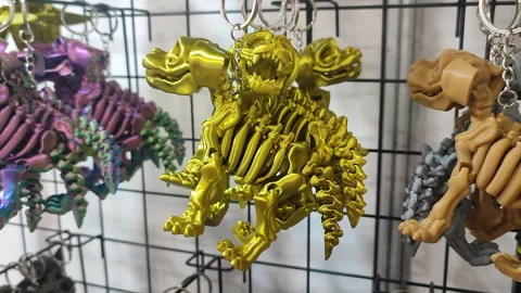 Objects keychains in form of different models of toys printed on 3D printer Stock Footage 303880708