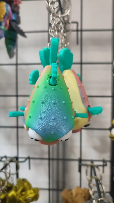 Objects keychains in form different models of toys printed 3D printer Vertical Stock Footage 303881443