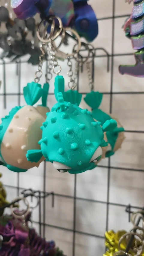 Objects keychains in form different models of toys printed 3D printer Vertical Stock Footage 303881468