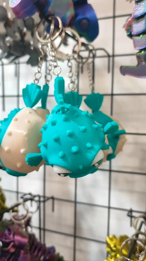 Objects keychains in form different models of toys printed 3D printer Vertical Stock Footage 304917747