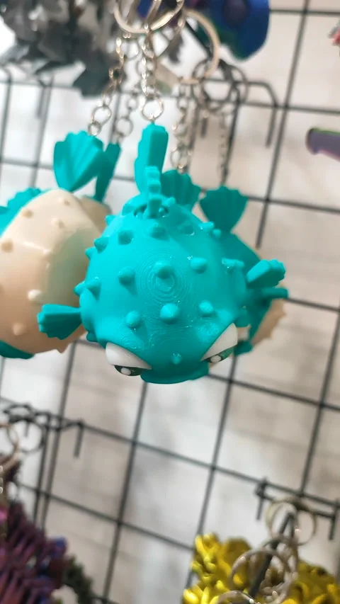 Objects keychains in form different models of toys printed 3D printer Vertical Stock Footage 305581997