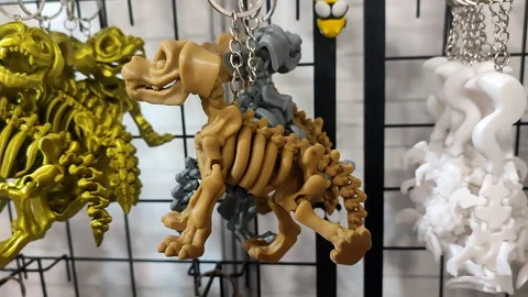 Objects keychains in form of dog skeleton models of toys printed on 3D printer Stockbeeldmateriaal 303881010