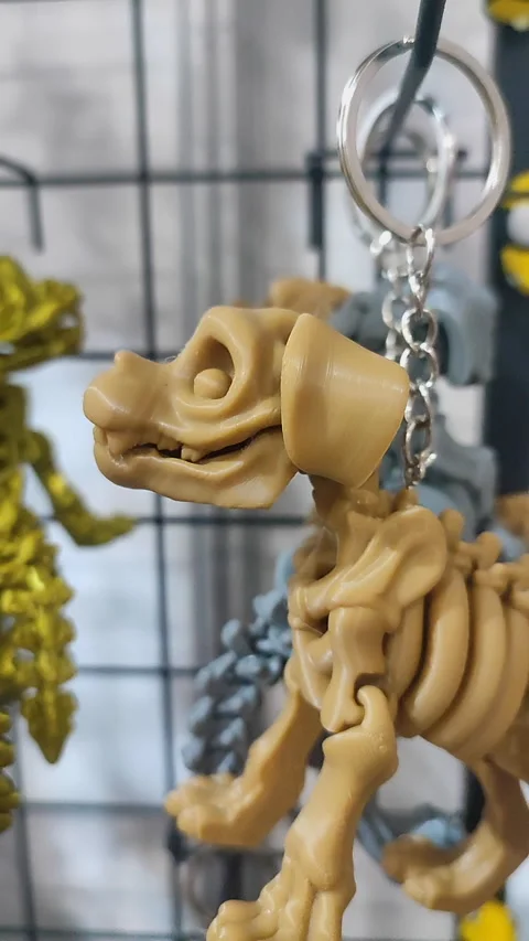 Objects keychains form dog skeleton models toys printed on 3D printer. Vertical Stock Footage 303881361