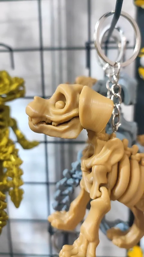 Objects keychains form dog skeleton models toys printed on 3D printer. Vertical Stock Footage 303953412