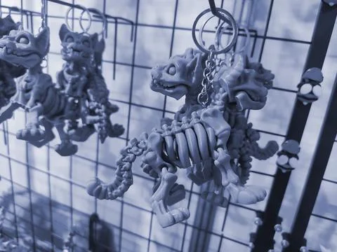 Objects keychains form dog skeleton models toys printed 3D printer. Blue color Stock Photos