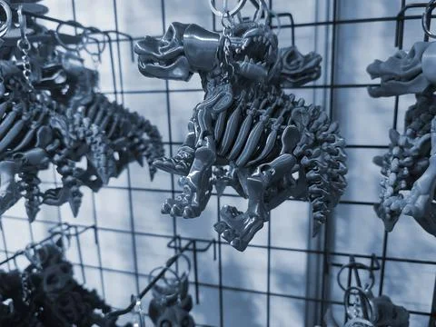 Objects keychains form dog skeleton models toys printed 3D printer. Blue color Stock Photos