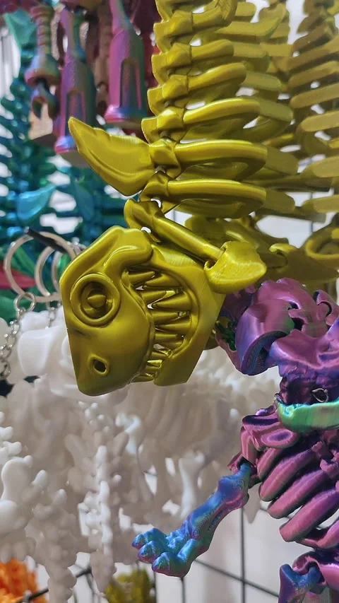 Objects keychains form fish skeleton models toys printed on 3D printer Vertical Stock Footage 304077919