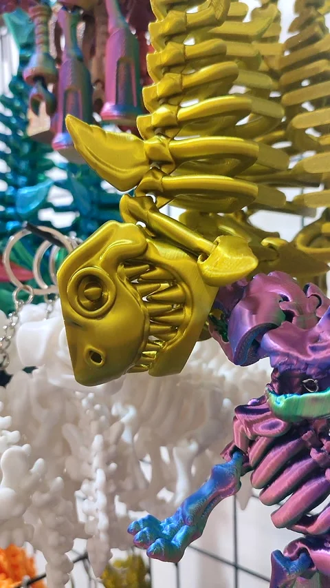 Objects keychains form fish skeleton models toys printed on 3D printer Vertical Video stock 304373426