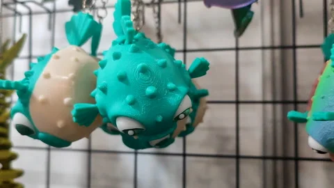 Objects keychains in form of models of fish toys printed on 3D printer Stock Footage 304074494