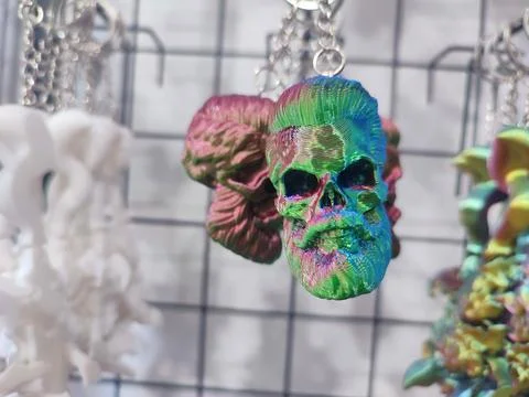 Objects keychains in form of skull of a man models of toys printed on 3D printer Stock Photos