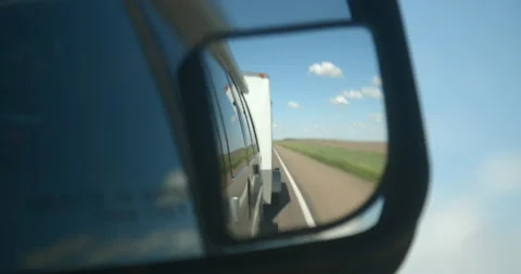 Objects in mirror are closer than they appear pulling a trailer. Focus Stock Footage 130182378