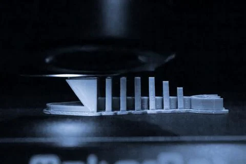 Objects printed by 3d printer. Automatic three dimensional 3d printer performs Stock Photos