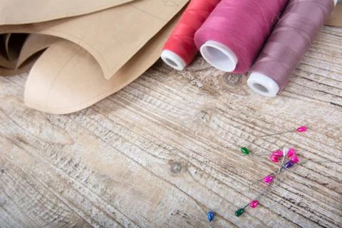 Objects for sewing clothes. Roulette, coil, and patterns on the table Stock Photos