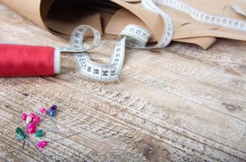 Objects for sewing clothes. Roulette, coil, and patterns on the table Stock Photos