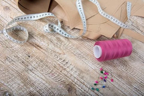 Objects for sewing clothes. Roulette, coil, and patterns on the table 스톡 사진