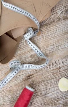 Objects for sewing clothes. Roulette, coil, and patterns on the table Stockfoto's