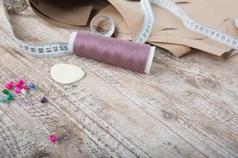 Objects for sewing clothes. Roulette, coil, and patterns on the table Stock Photos